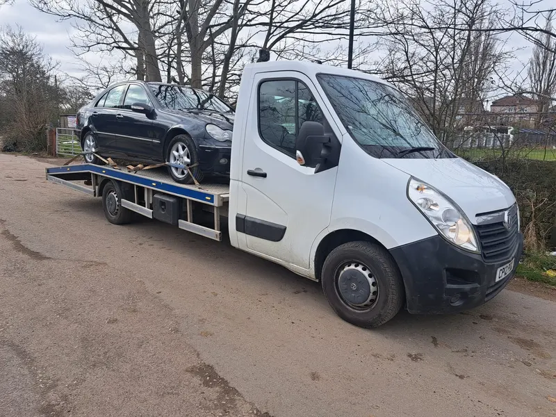 Car on a recovery truck collected for scrap in Preston
